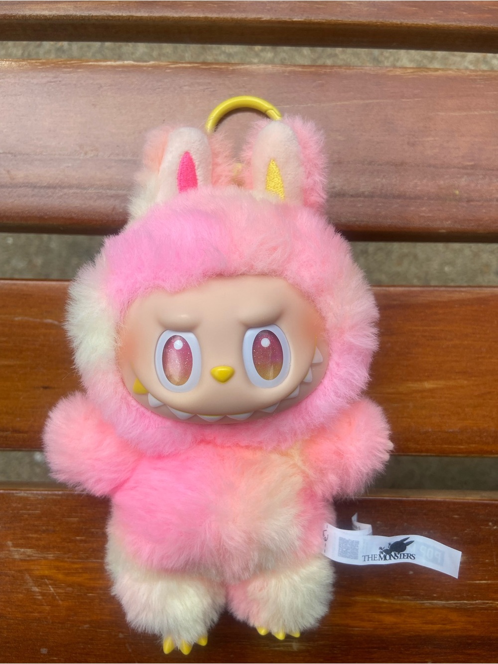 Popmart Labubu “Big Into Energy” keychain in pink and yellow tie-dye.